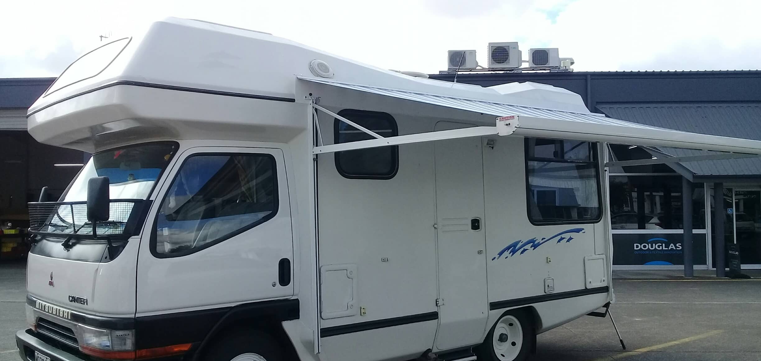 A motorhome with awning on a grey day