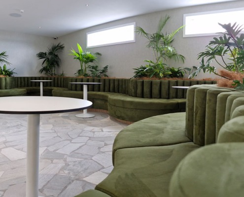 Closeup of bolsters made out of green fabric plus custom curved squab seating