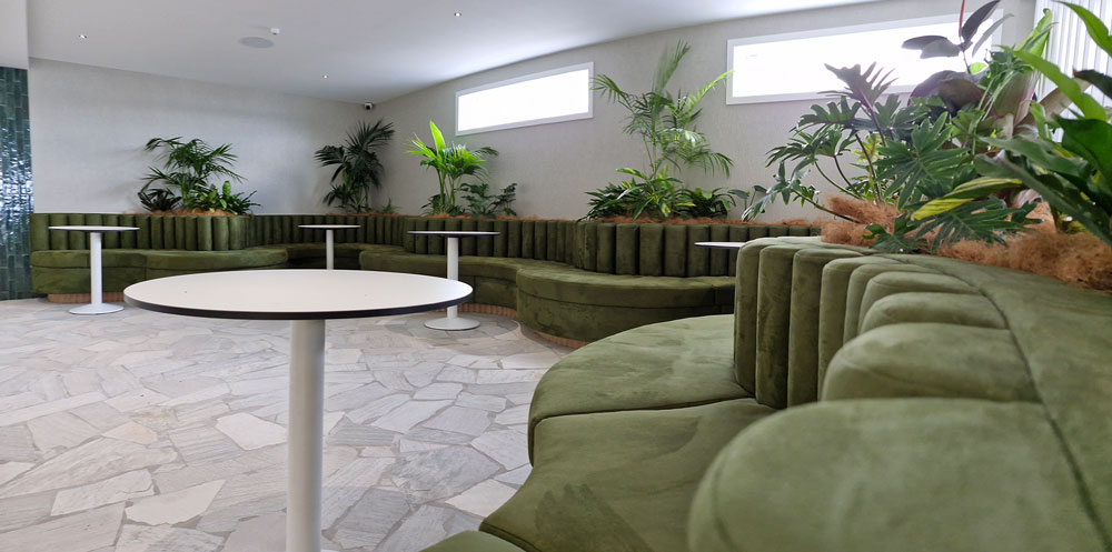 Closeup of bolsters made out of green fabric plus custom curved squab seating