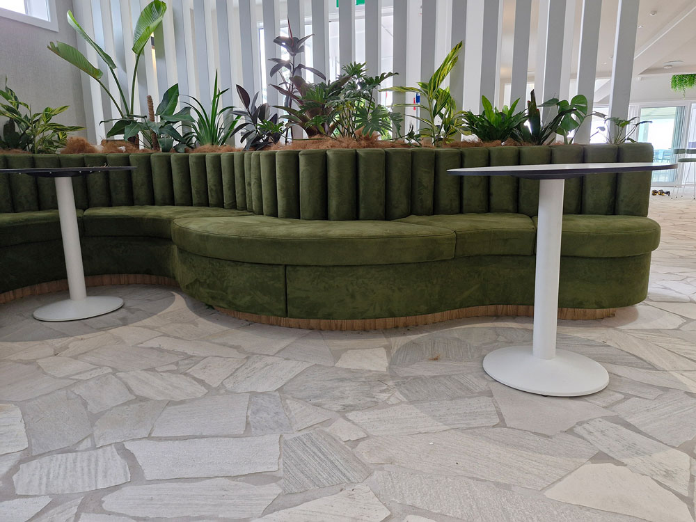 Interior of cocktail Bar with custom squab seating and round tables frontal view