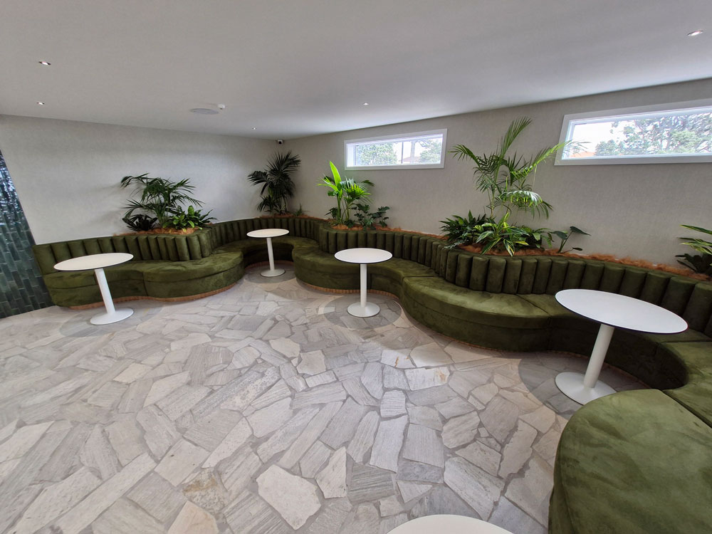 Interior of cocktail Bar with custom squab seating and round tables