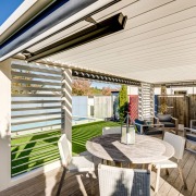 An outdoor living louvre roof space with inbuilt patio heater